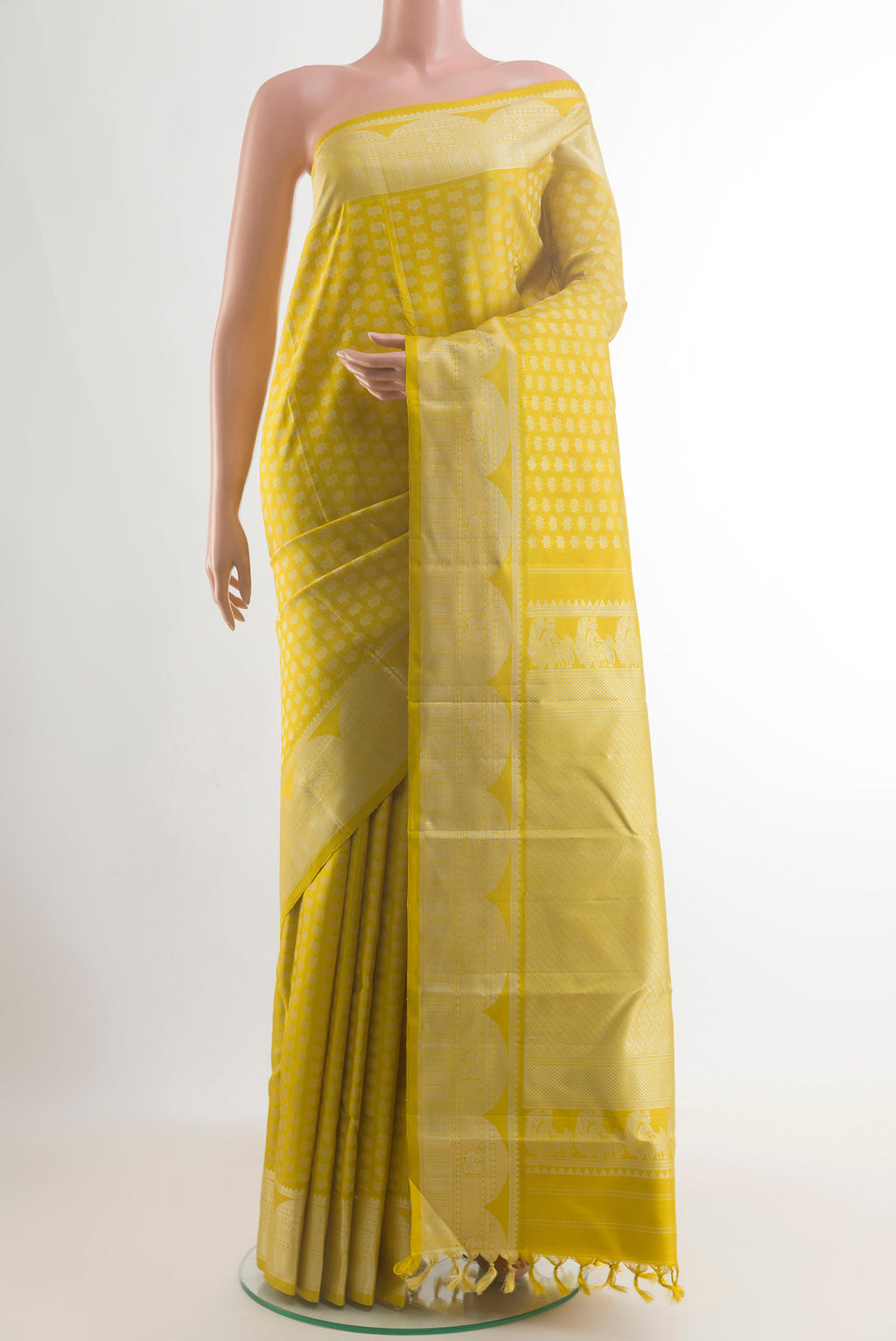 Pure Silk Yellow Kanjivaram Saree with Thread Butta on the body and Thread Border.  displayed on a mannequin