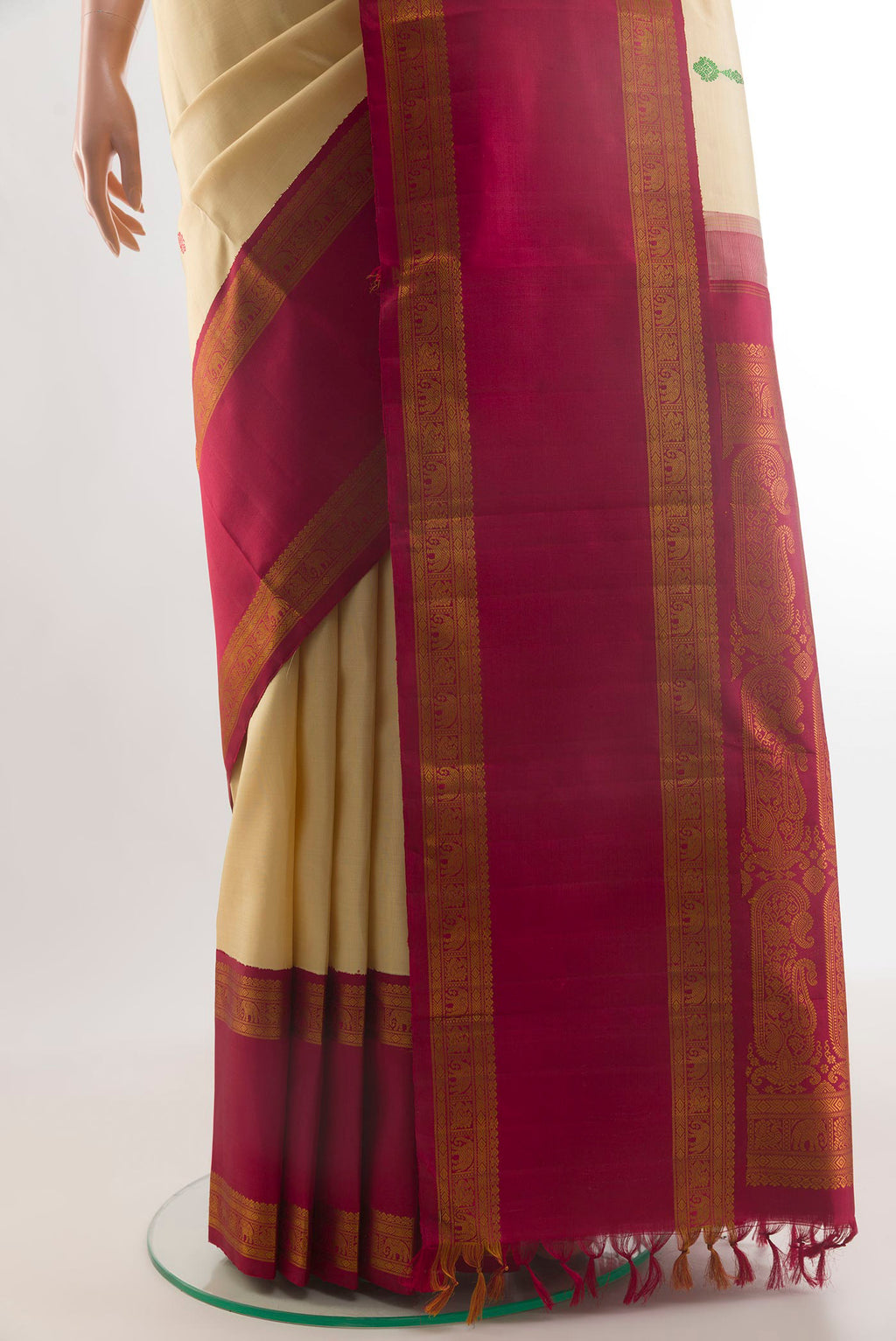 Pleats and pallu of Pure Silk Sandal Kanjivaram Saree with Thread Butta on the body and Zari Border. 