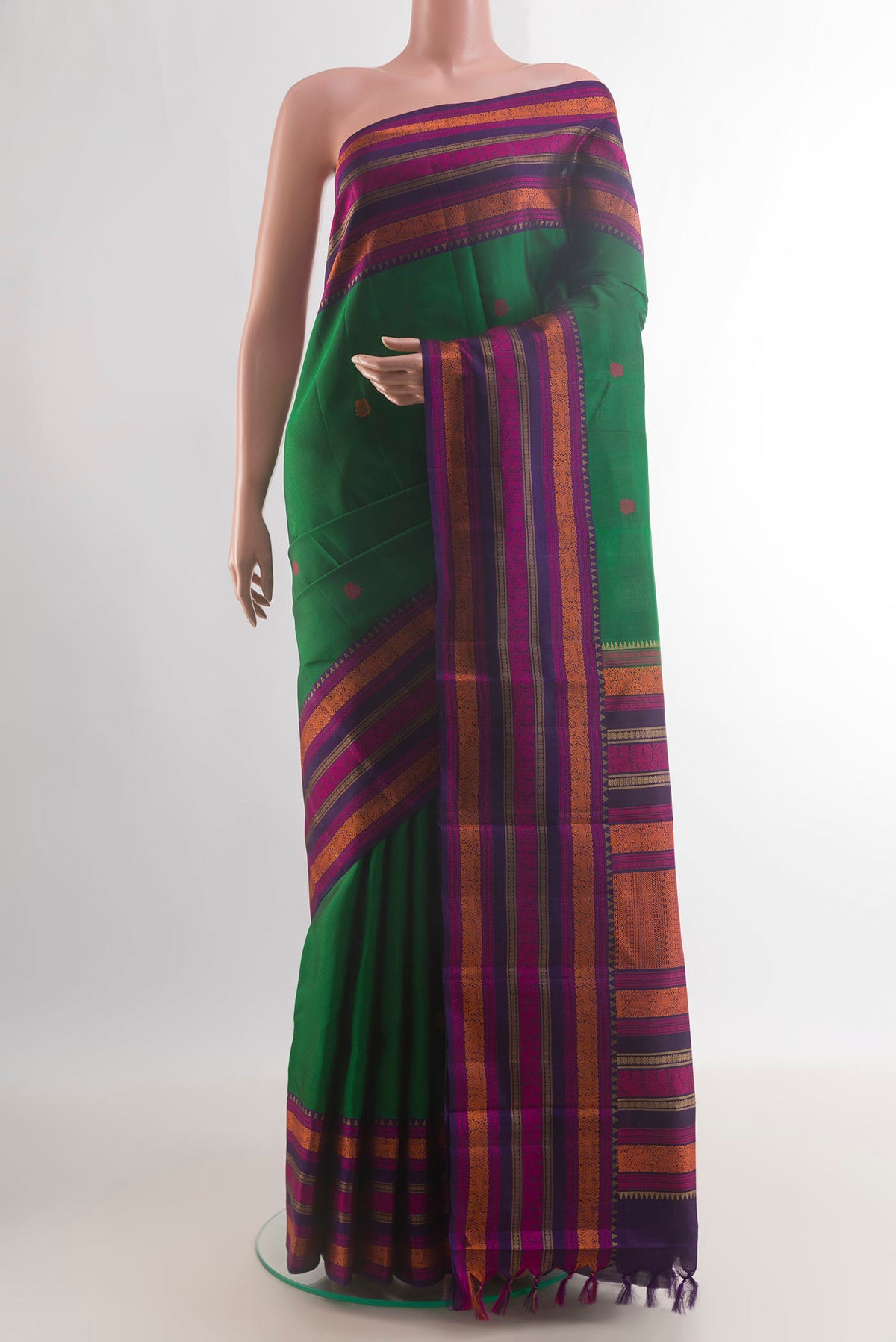 Pure Silk Green Kanchipuram Saree with Thread Butta on the body and Thread Border.  displayed on a mannequin