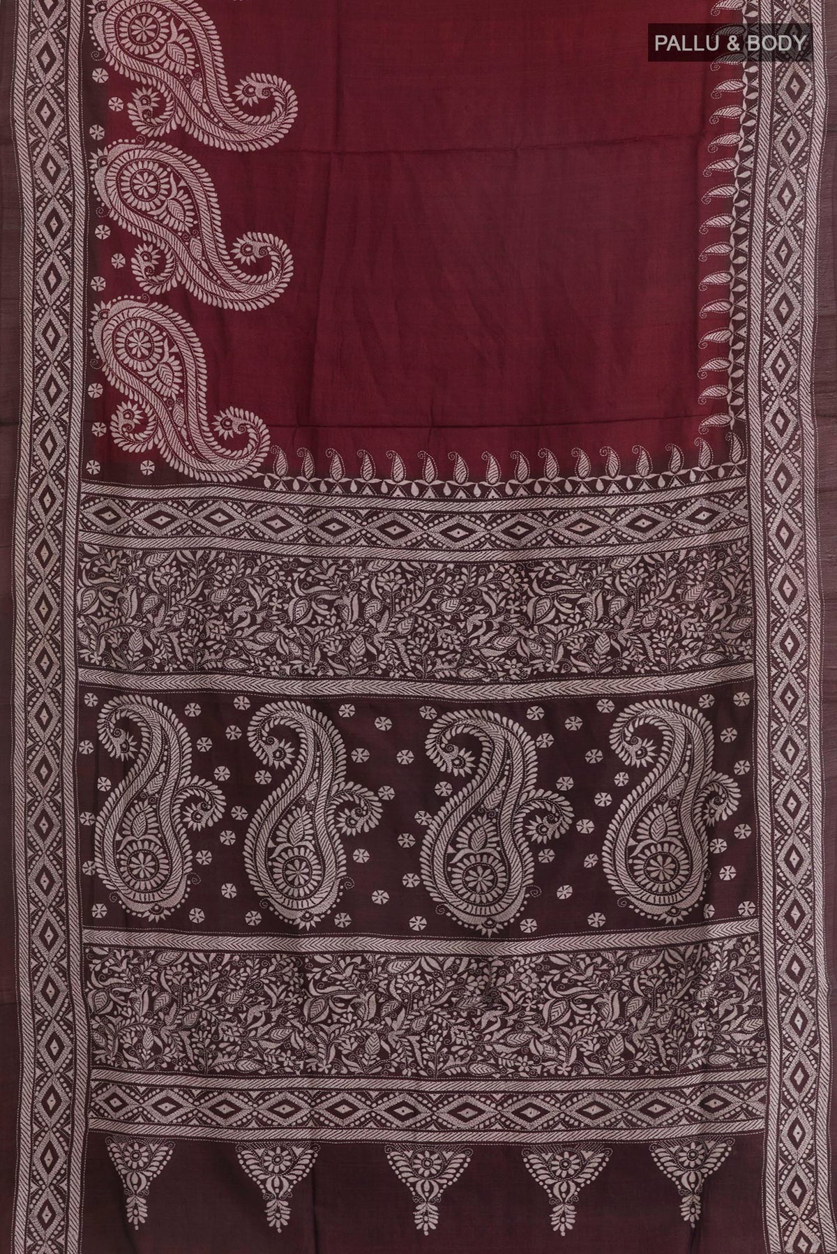 Flat view of Maroon Tussar Saree with Kantha Work on the body and Embroidery Border. 
