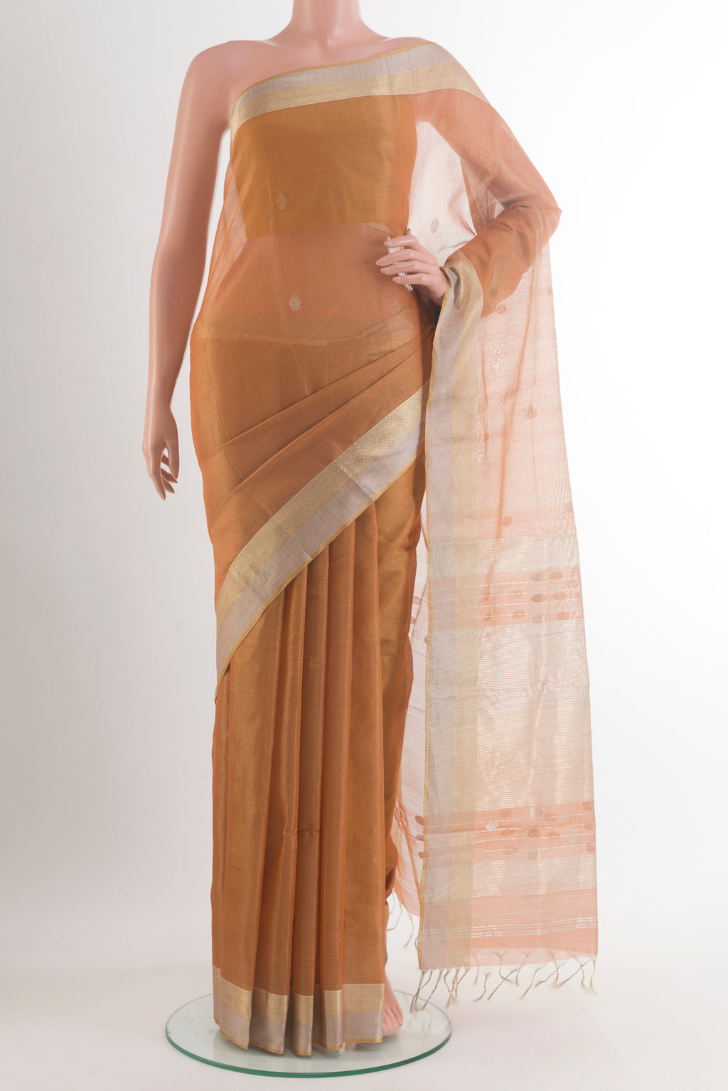 Caramel Blended Maheshwari Silk Cotton Saree with Zari Butta on the body and Zari Border.  displayed on a mannequin