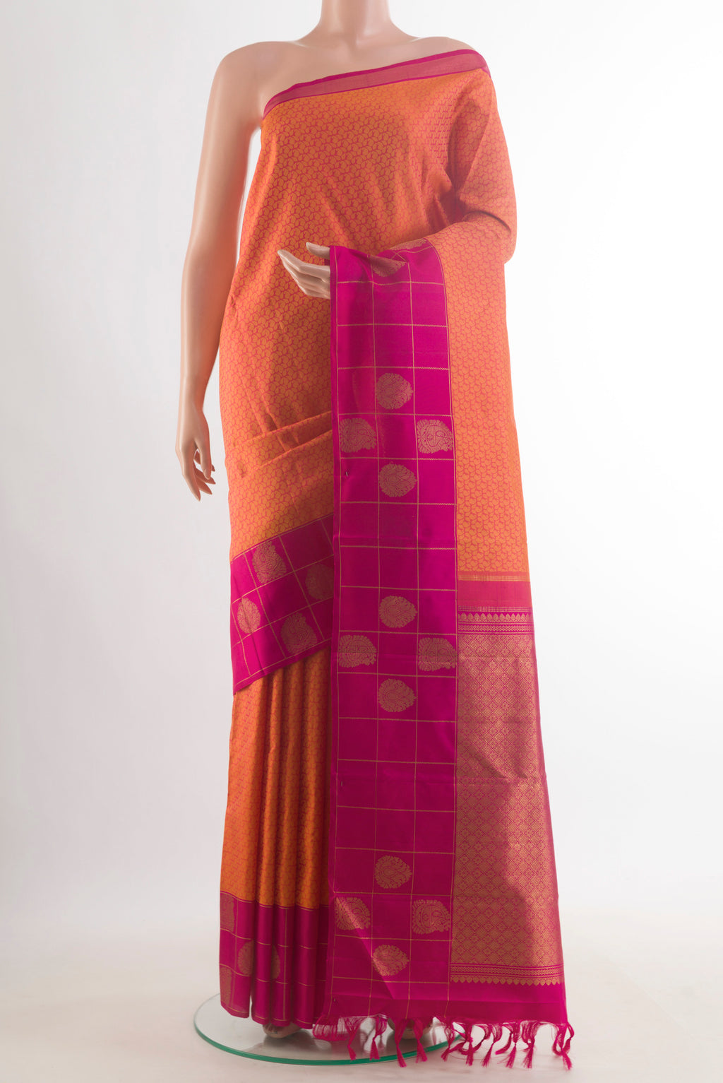 Pure Silk Orange Kanjivaram Saree with Jacquard design on the body and Zari Border.  displayed on a mannequin