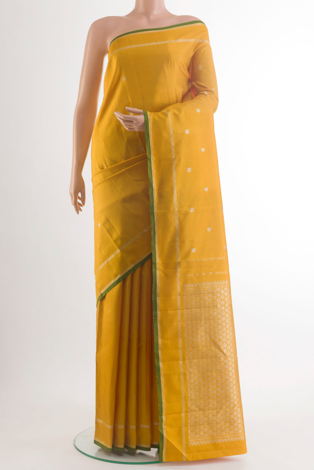 Pure Silk Mustard Kanchipuram Saree with Zari Butta on the body and Zari Border.  displayed on a mannequin