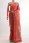 Pure Silk Brick Orange Kanchipuram Saree with Zari Butta on the body and Zari Border.  displayed on a mannequin