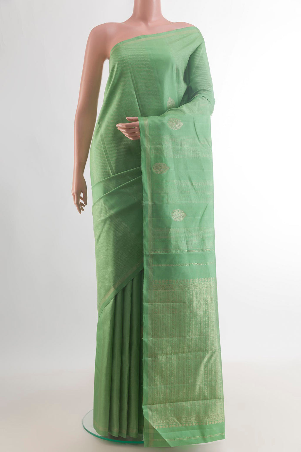 Pure Silk Green Kanchipuram Saree with Zari Butta on the body and Without Border.  displayed on a mannequin