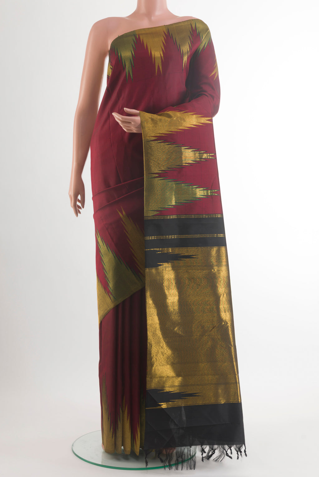 Pure Silk Maroon Kanjivaram Saree with Plain Body and Temple Border.  displayed on a mannequin