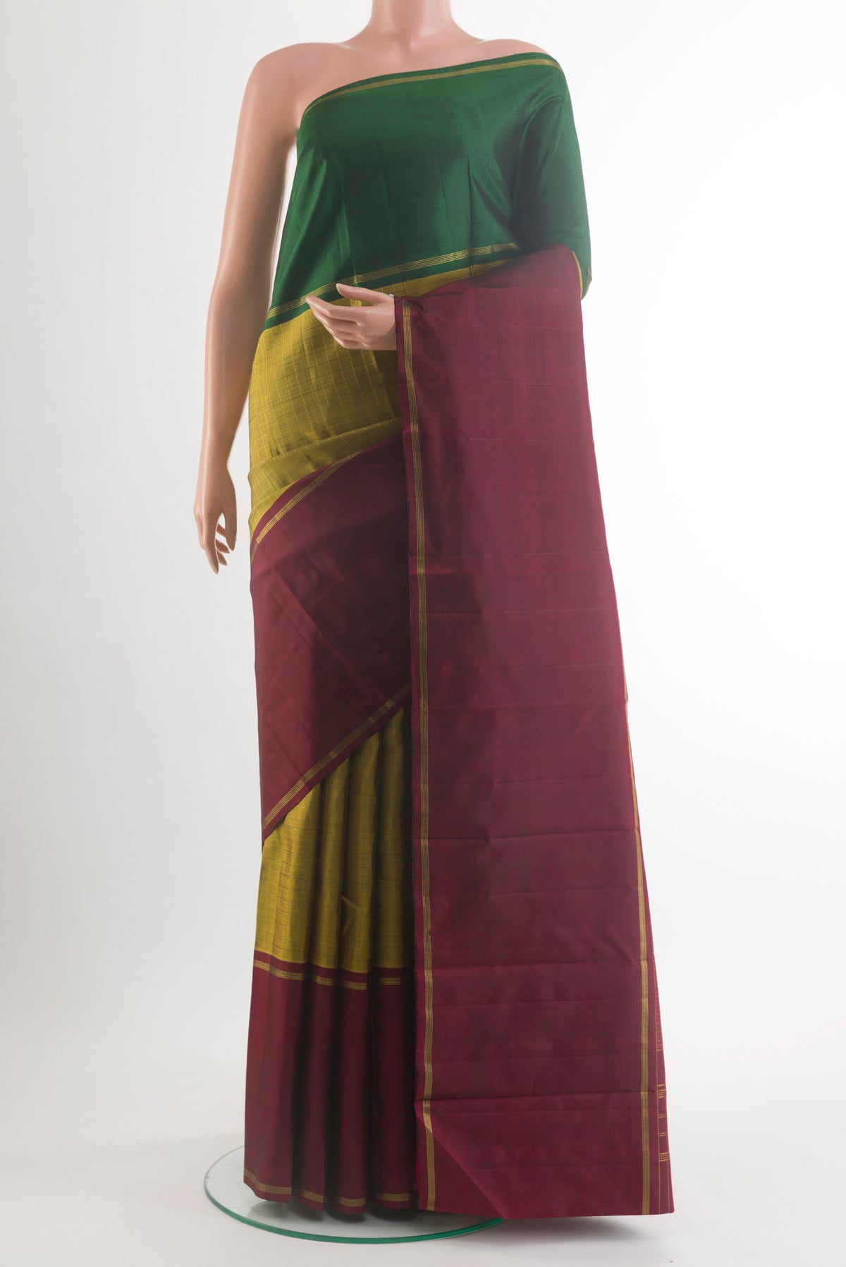 Pure Silk Mehandi Green Kanjivaram Saree with Checked design on the body and Ganga Jamuna Border.  displayed on a mannequin
