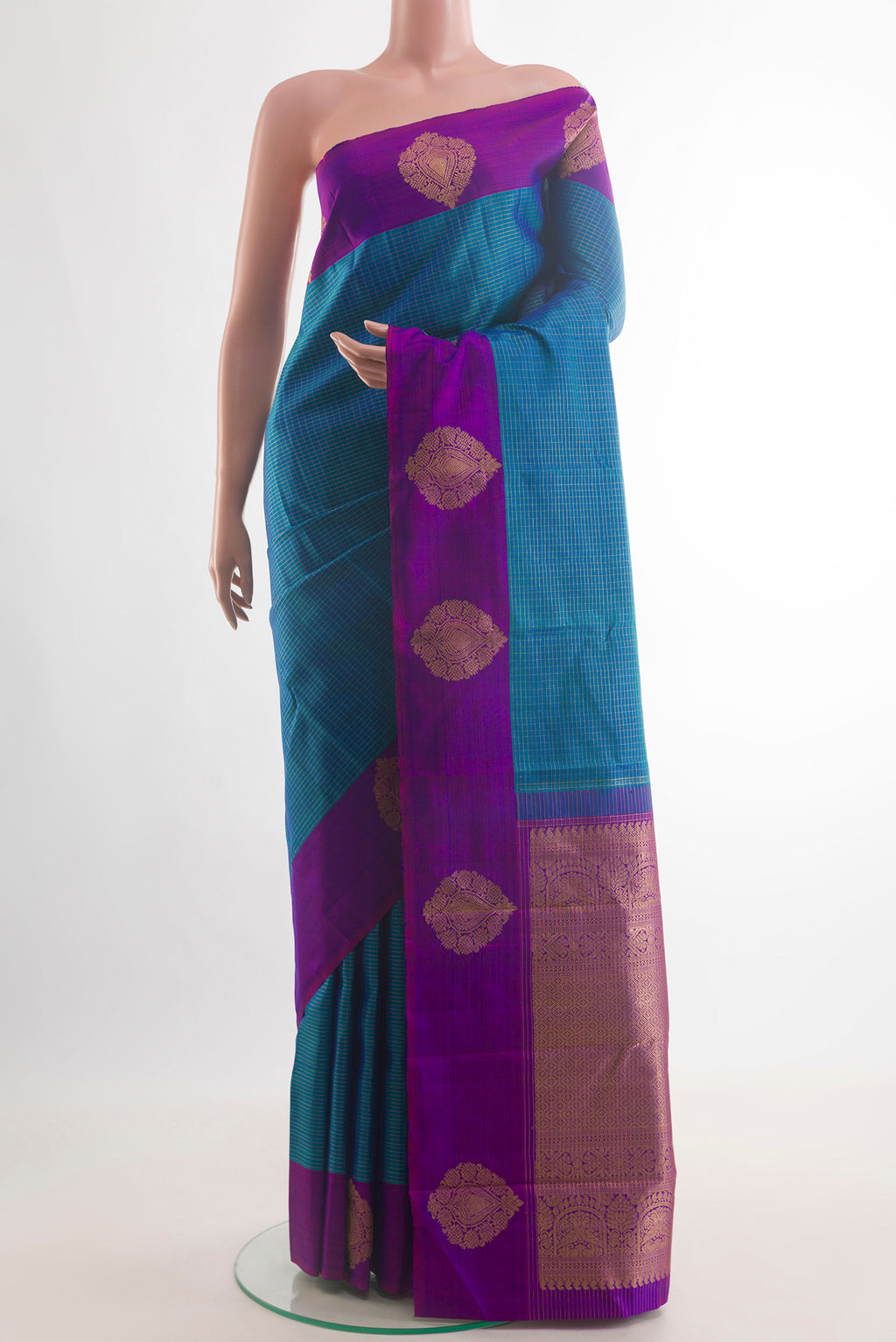 Pure Silk Peacock Blue Kanjivaram Saree with Checked design on the body and Zari Border.  displayed on a mannequin
