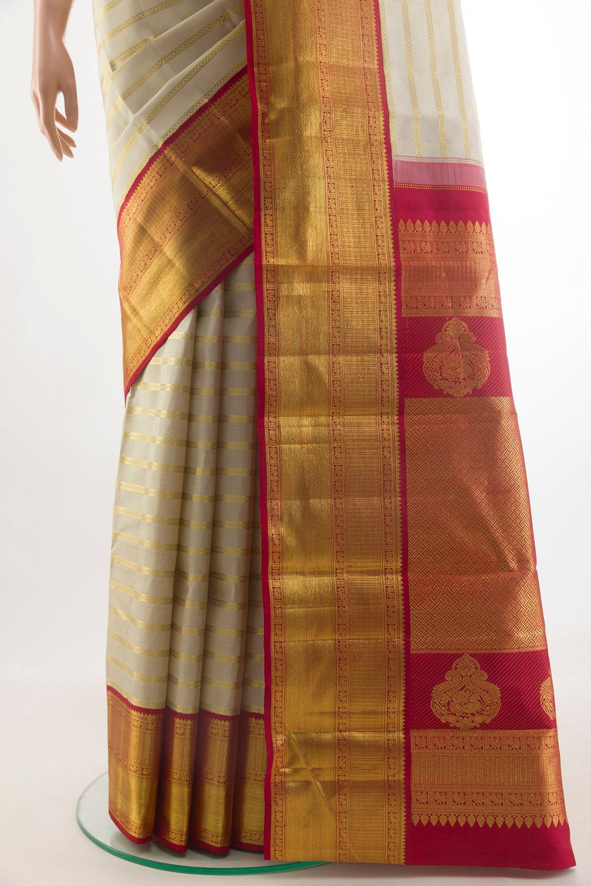 Pleats and pallu of Pure Silk Off White Kanchipuram Saree with Stripes on the body and Zari Border. 