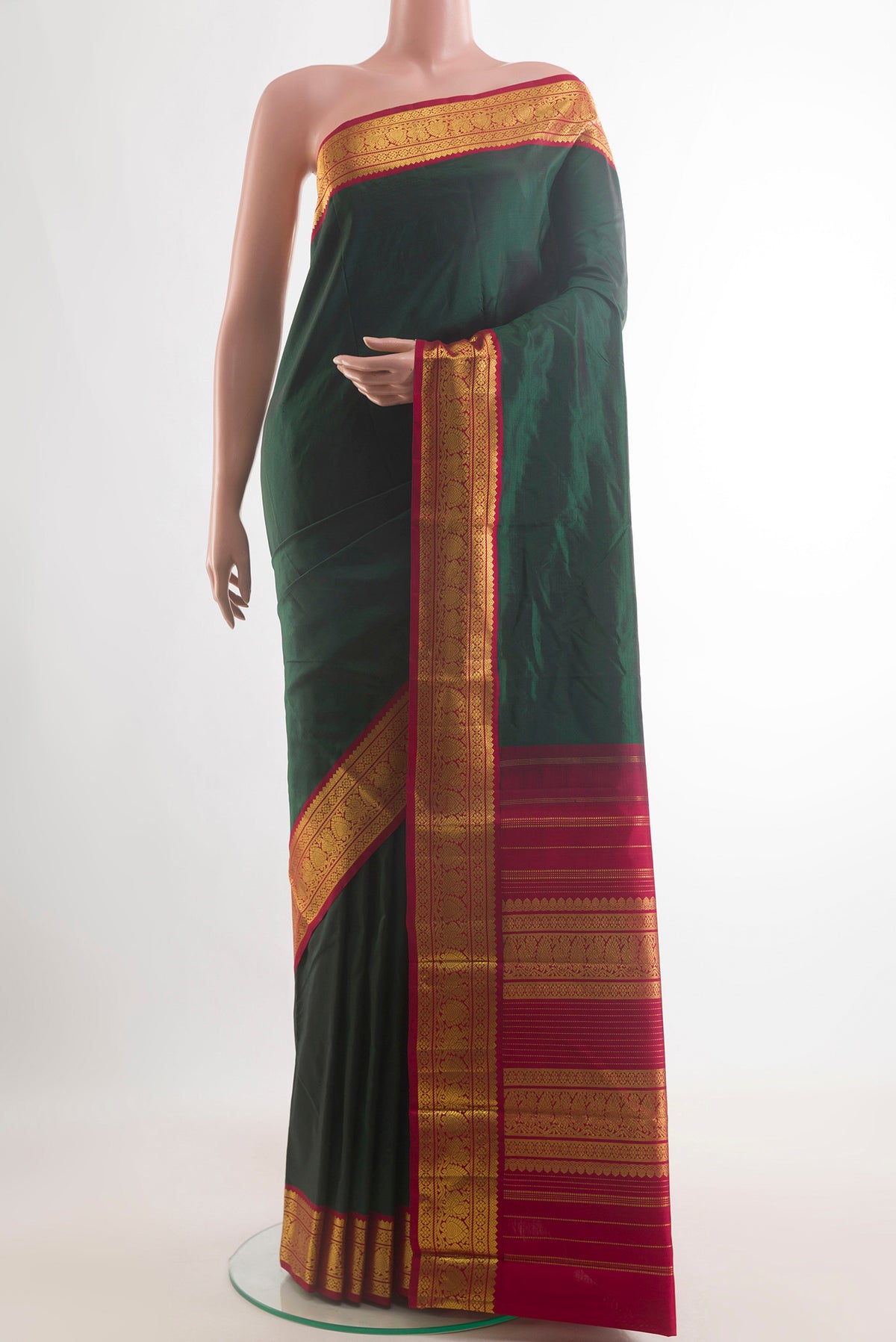 Pure Silk Bottle Green Kanjivaram Saree with Plain Body and Zari Border.  displayed on a mannequin