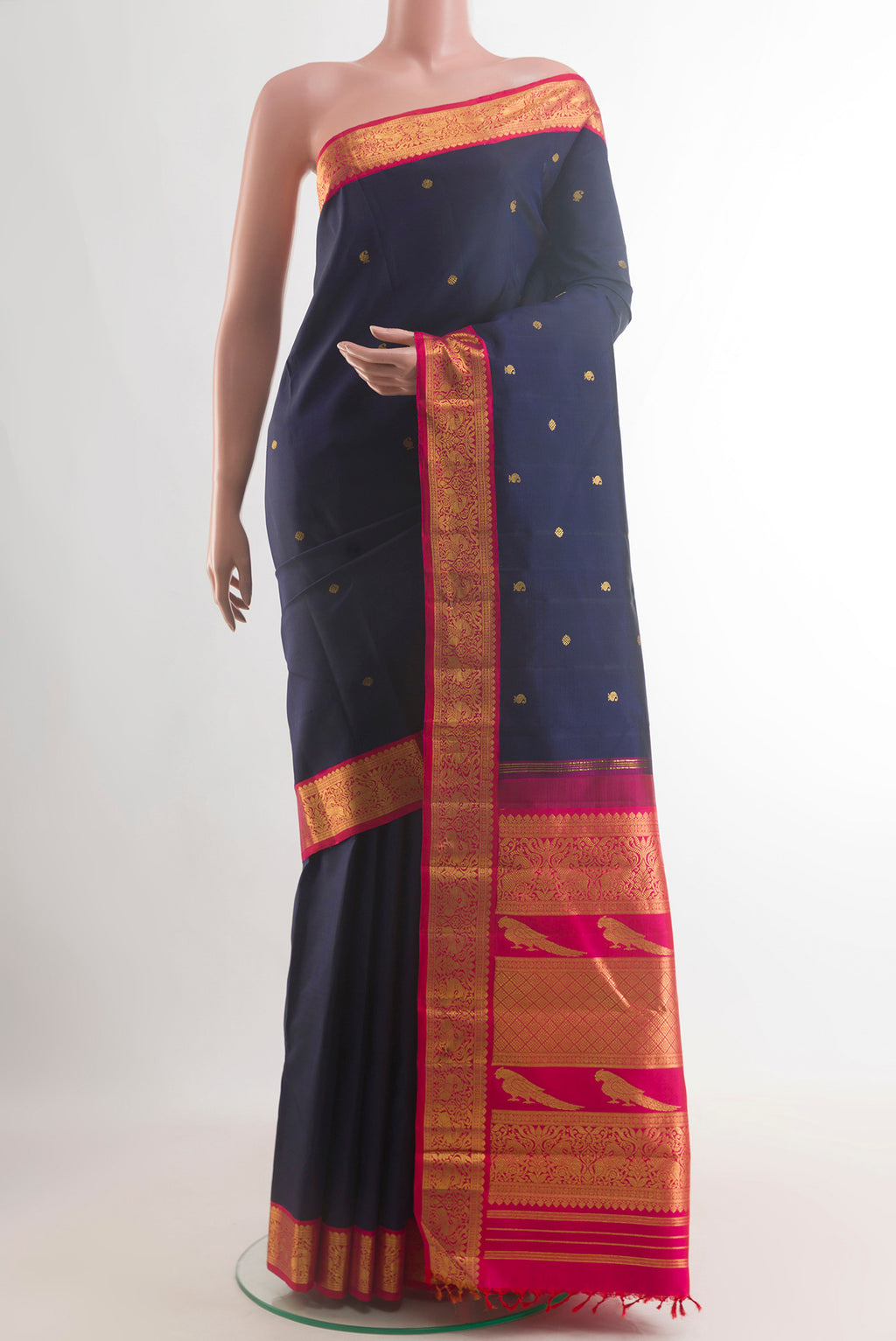 Pure Silk Navy Blue Kanchipuram Saree with Zari Butta on the body and Zari Border.  displayed on a mannequin