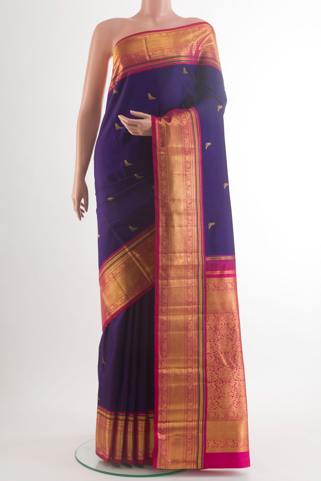 Pure Silk Pure Zari Navy Blue Kanchipuram Saree with Zari Butta on the body and Zari Border.  displayed on a mannequin