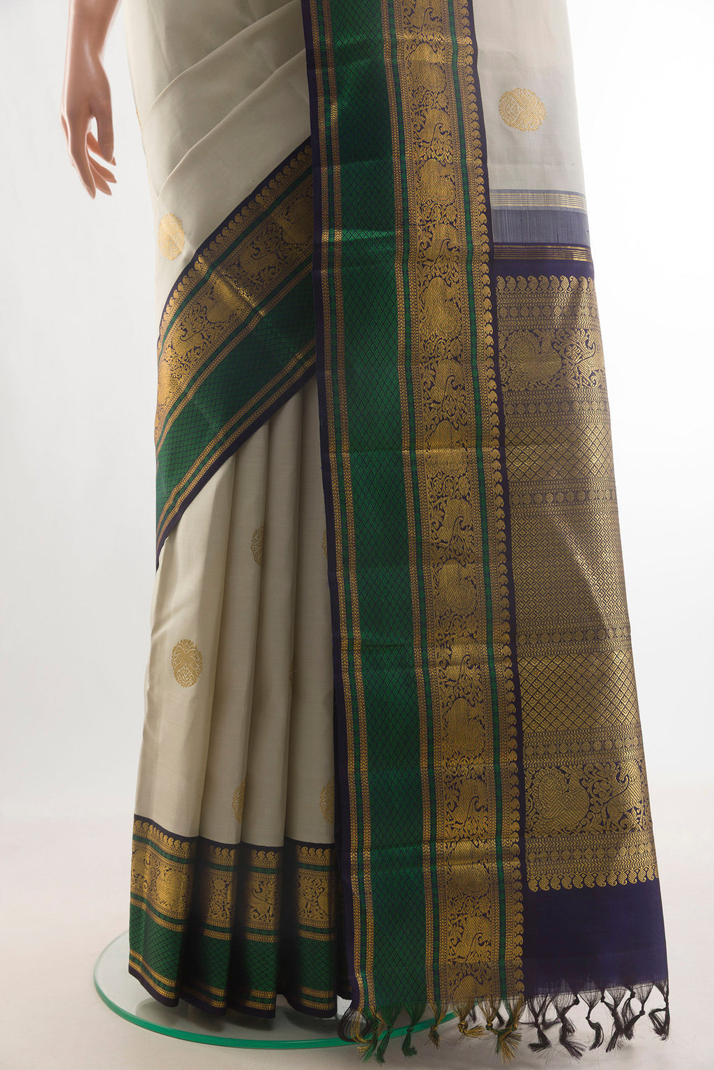 Pleats and pallu of Pure Silk Off White Kanchipuram Saree with Zari Butta on the body and Zari Border. 