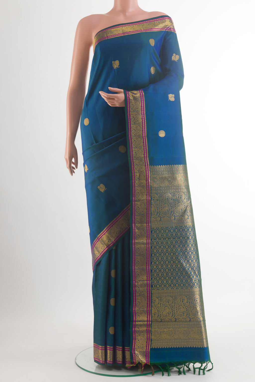 Pure Silk Peacock Blue Kanchipuram Saree with Zari Butta on the body and Zari Border.  displayed on a mannequin