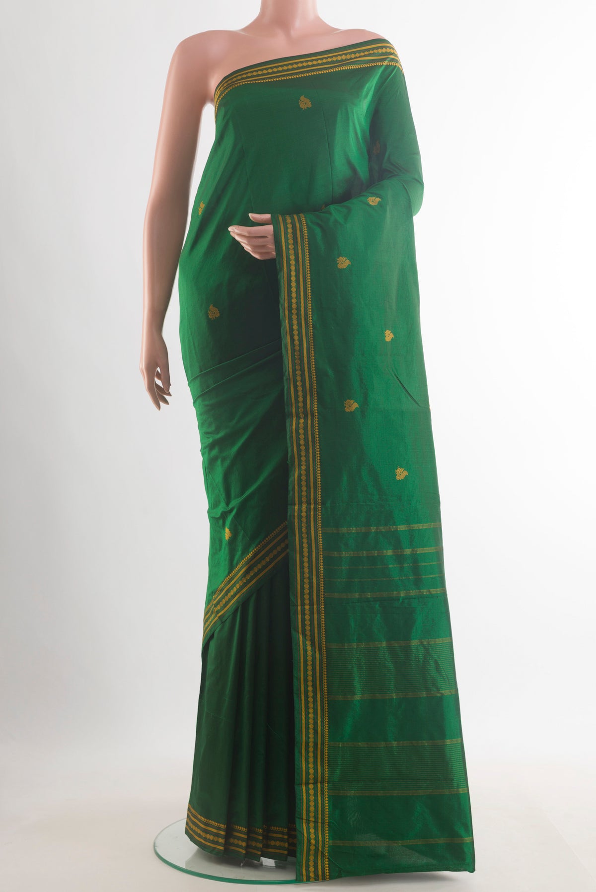 Pure Silk Green Kanchipuram Saree with Thread Butta on the body and Thread Border.  displayed on a mannequin