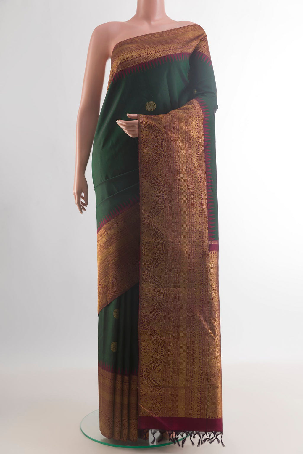 Pure Silk Green Kanchipuram Saree with Zari Butta on the body and Zari Border.  displayed on a mannequin