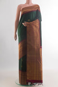 Pure Silk Green Kanchipuram Saree with Zari Butta on the body and Zari Border.  displayed on a mannequin