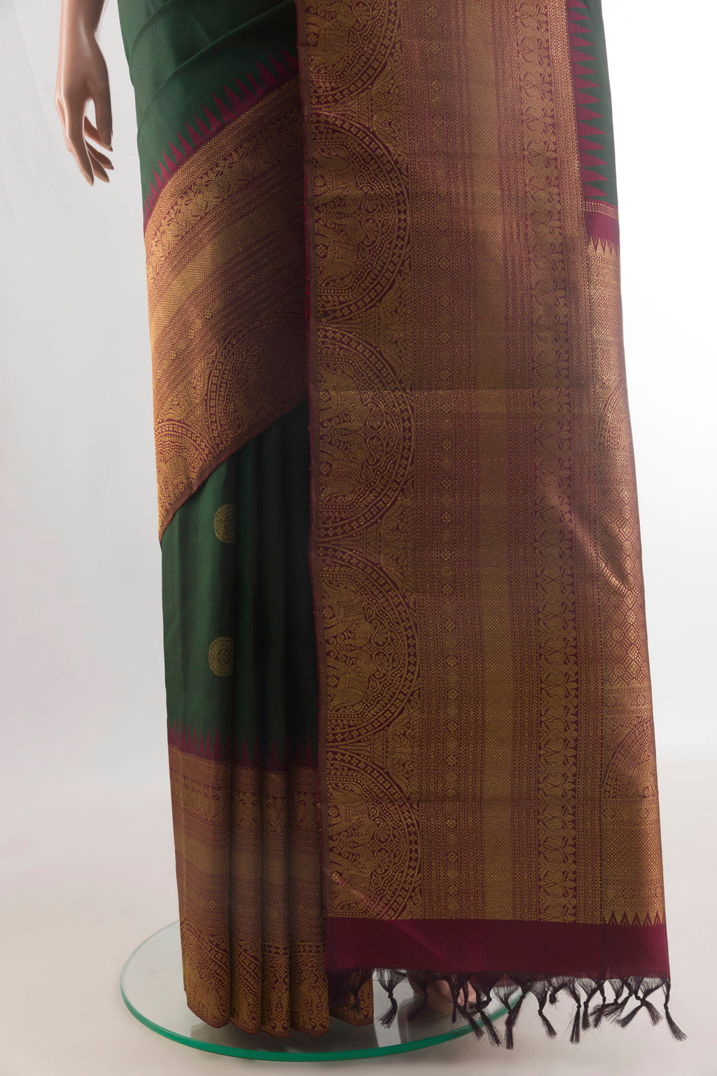 Pleats and pallu of Pure Silk Green Kanchipuram Saree with Zari Butta on the body and Zari Border. 