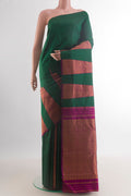 Pure Silk Green Kanchipuram Saree with Plain Body and Temple Border.  displayed on a mannequin
