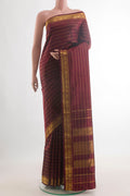 Pure Silk Maroon Kanchipuram Saree with Stripes on the body and Zari Border.  displayed on a mannequin