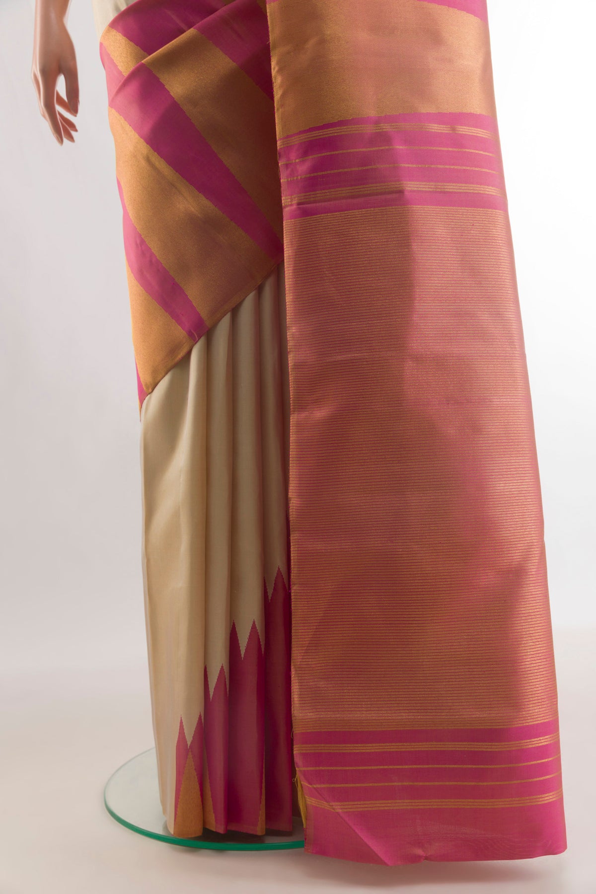 Pleats and pallu of Pure Silk Cream Kanjivaram Saree with Plain Body and Rising Temple Border. 