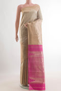 Pure Silk Beige Kanchipuram Saree with Zari Butta on the body and Zari Border.  displayed on a mannequin