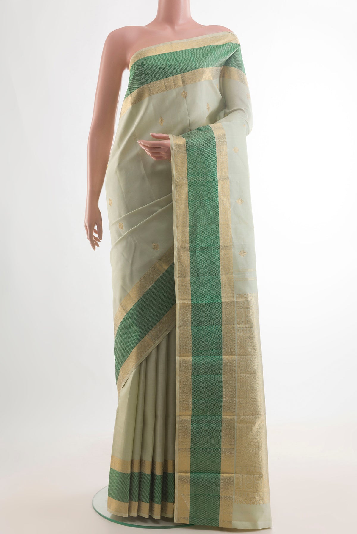 Pure Silk Light Green Kanjivaram Saree with Zari Butta on the body and Zari Border.  displayed on a mannequin