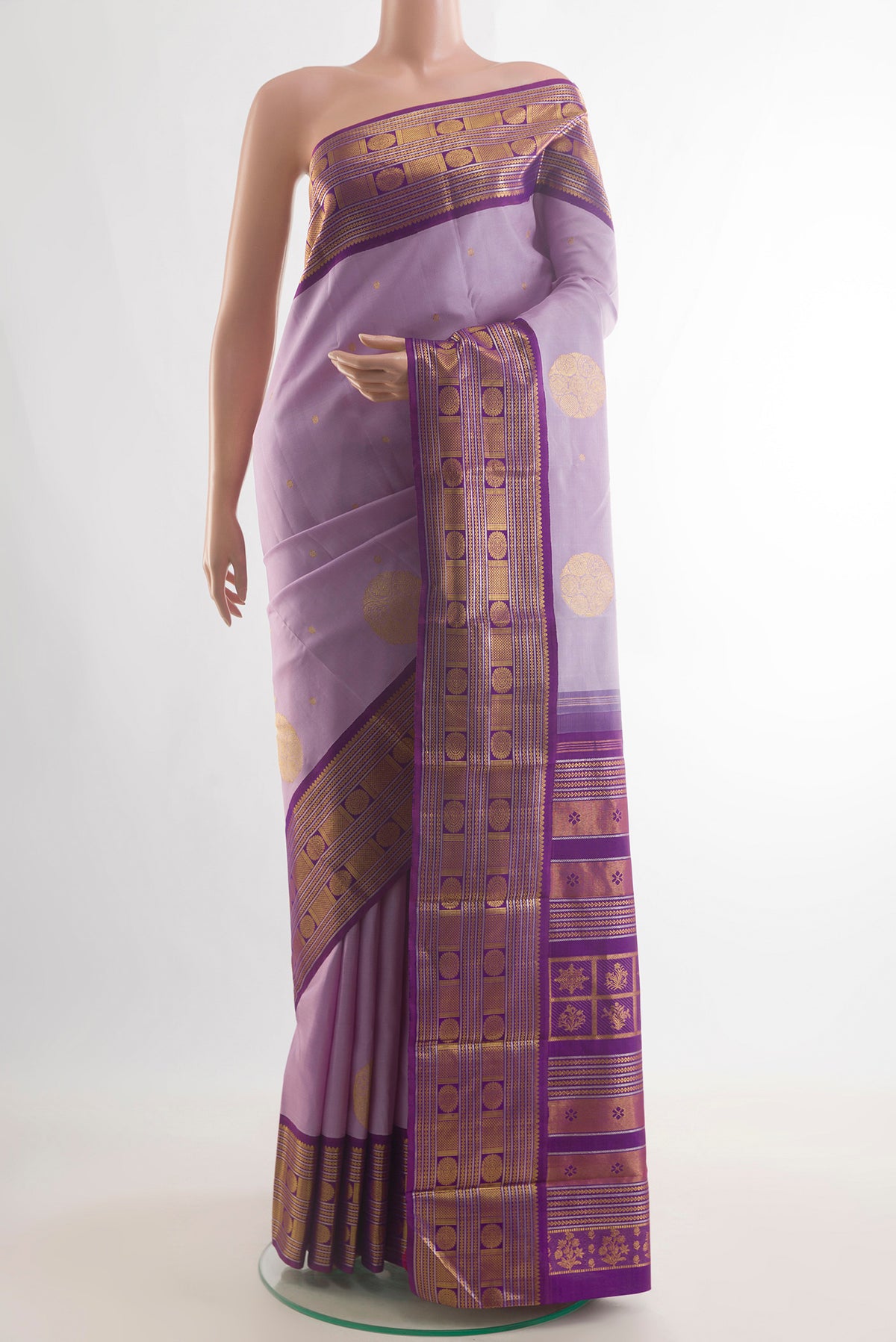 Pure Silk Lavender Kanjivaram Saree with Zari Butta on the body and Zari Border.  displayed on a mannequin