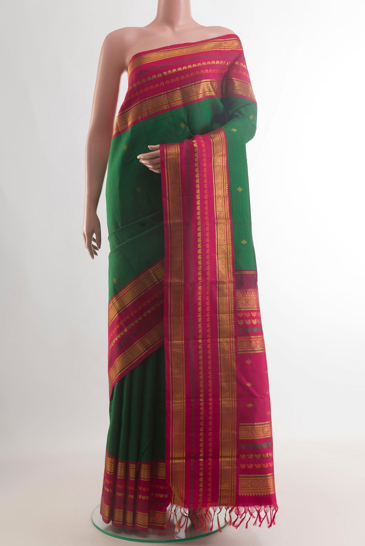 Pure Silk Green Kanchipuram Saree with Zari Butta on the body and Zari Border.  displayed on a mannequin