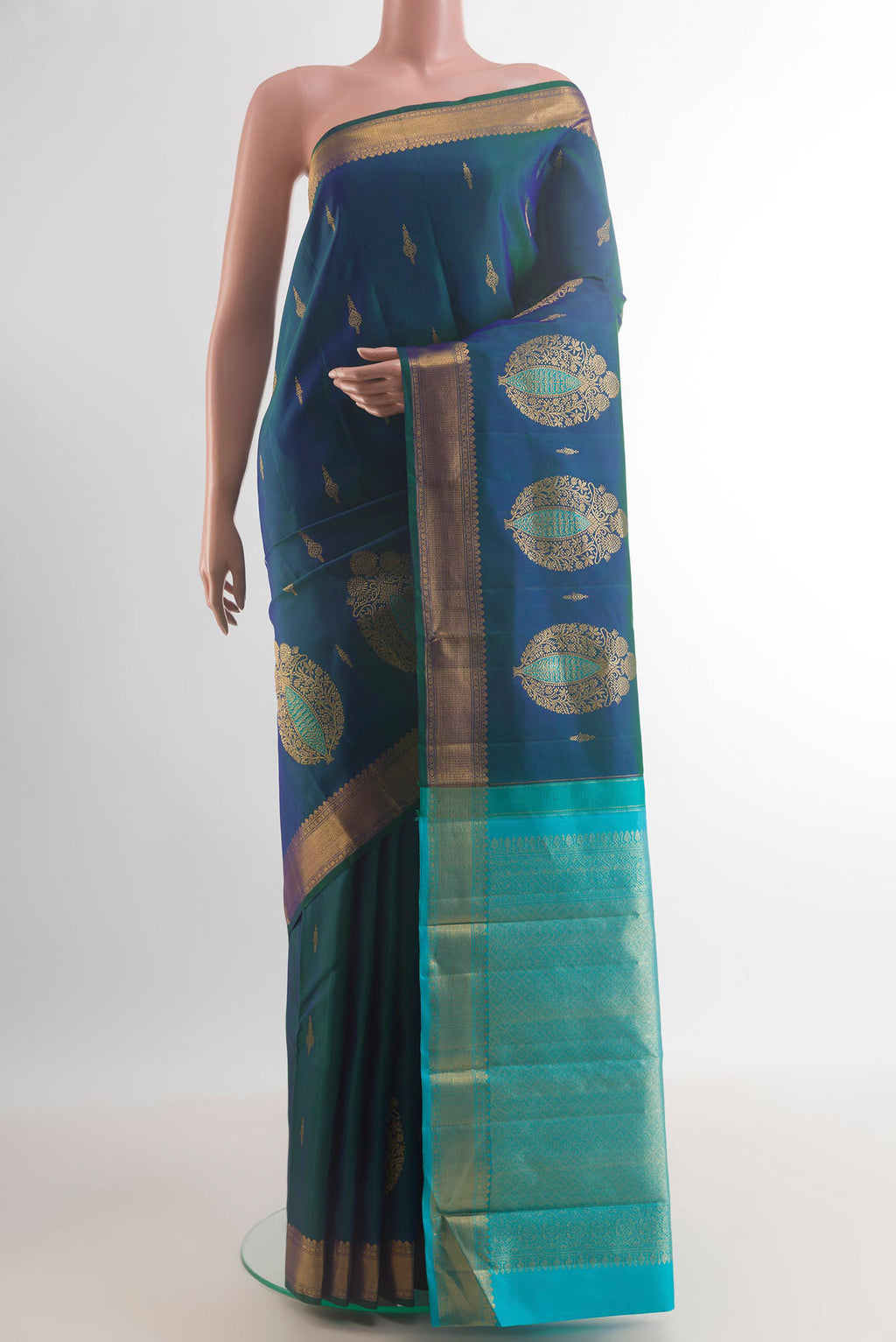 Pure Silk Peacock Blue Kanjivaram Saree with Zari Butta on the body and Zari Border.  displayed on a mannequin