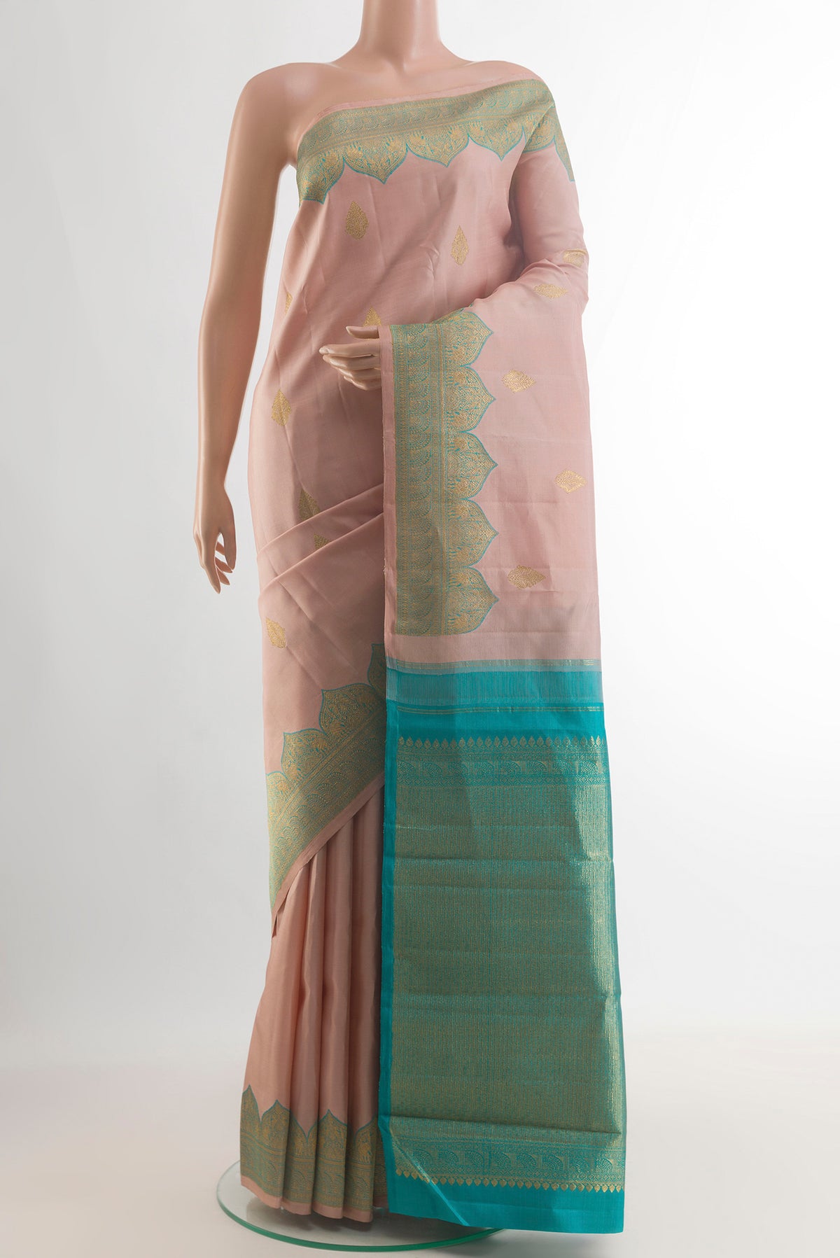 Pure Silk Rose Gold Kanjivaram Saree with Zari Butta on the body and Zari Border.  displayed on a mannequin