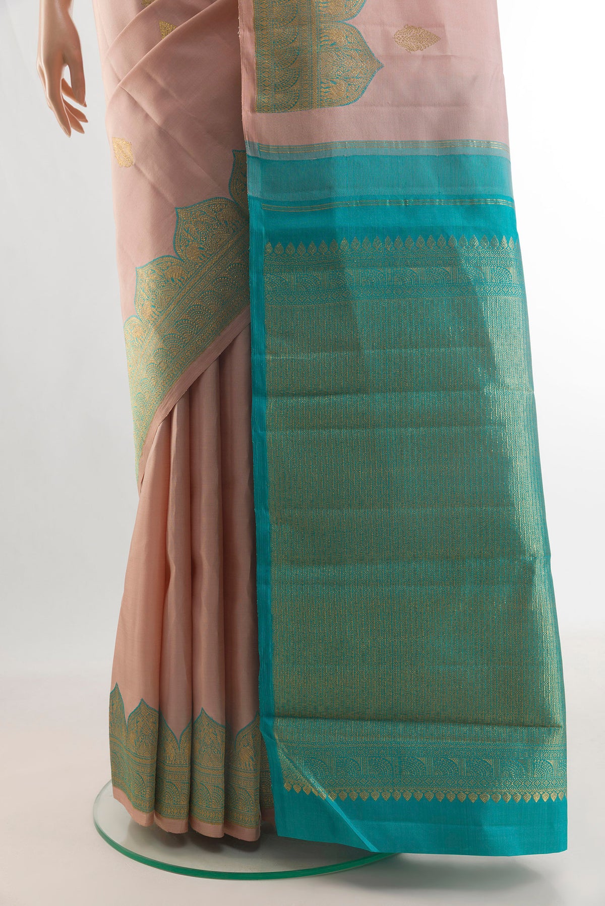 Pleats and pallu of Pure Silk Rose Gold Kanjivaram Saree with Zari Butta on the body and Zari Border. 