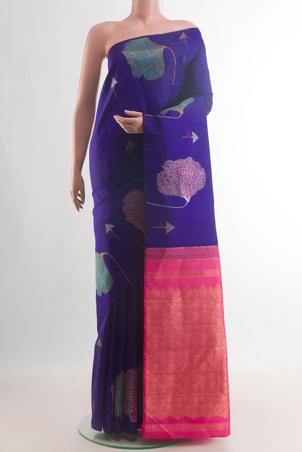 Pure Silk Blue Kanjivaram Saree with Zari And Thread Butta on the body and Without Border.  displayed on a mannequin