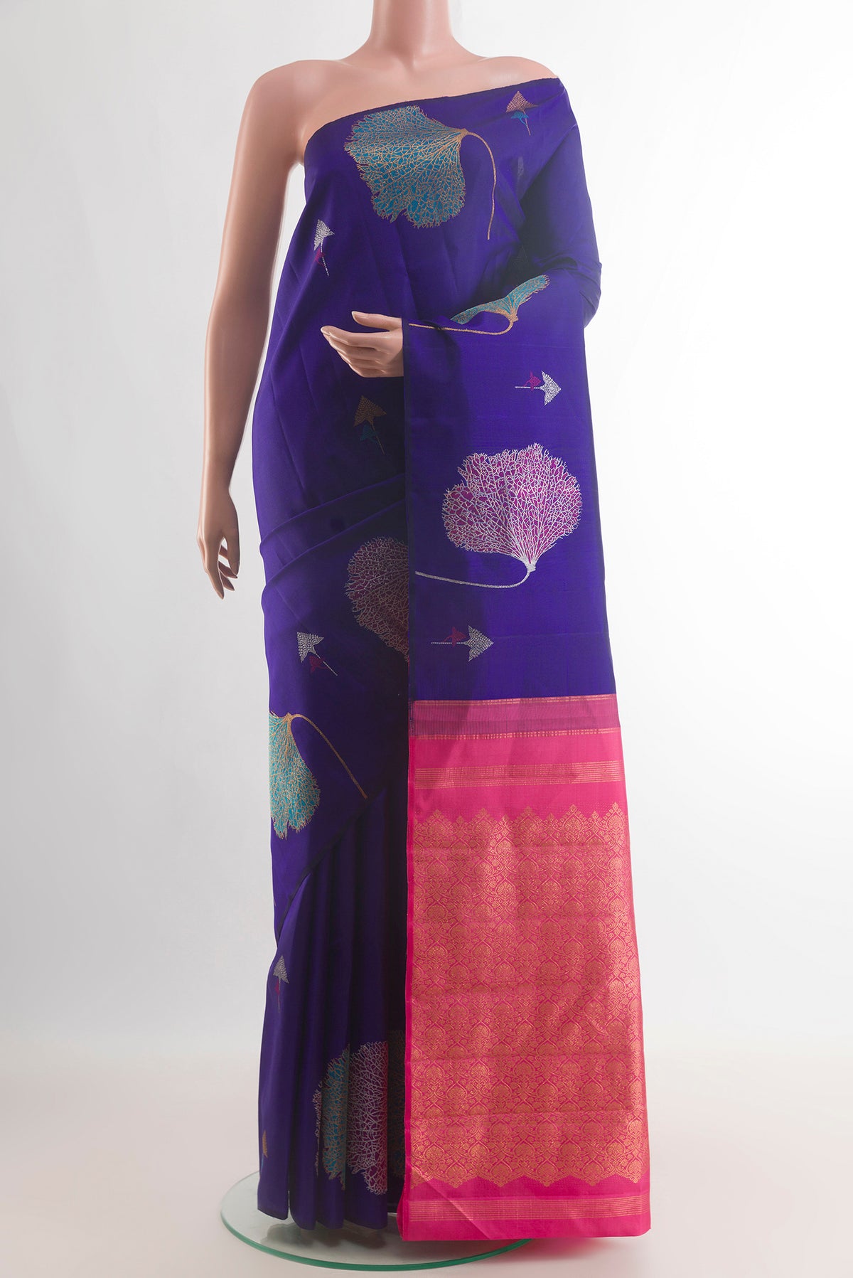 Pure Silk Blue Kanjivaram Saree with Zari And Thread Butta on the body and Without Border.  displayed on a mannequin