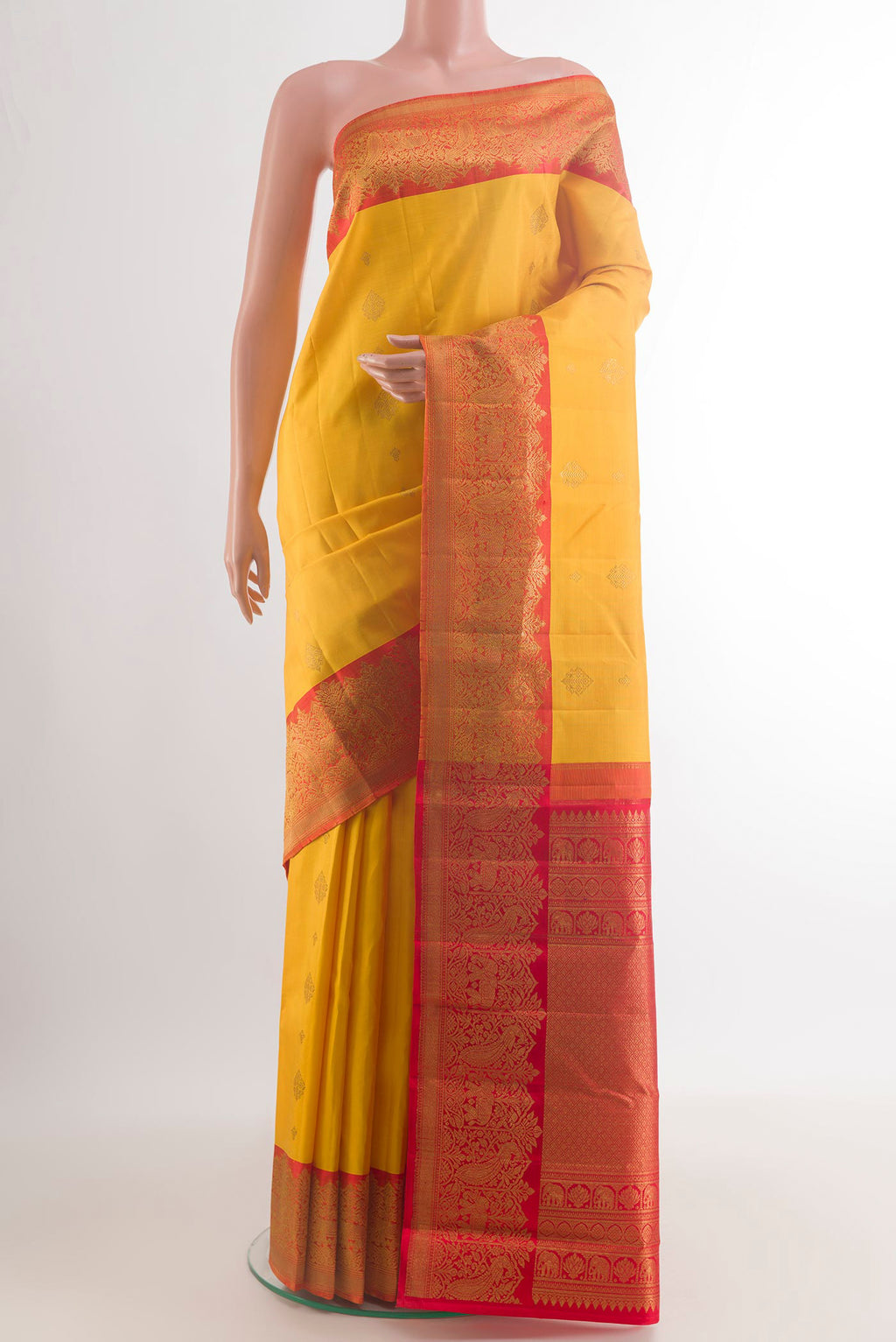 Pure Silk Yellow Kanjivaram Saree with Zari Butta on the body and Zari Border.  displayed on a mannequin