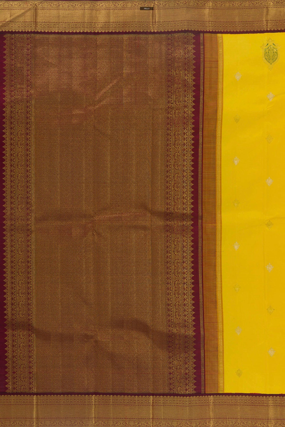 Close up image of the pallu of Pure Silk Yellow Kanjivaram Saree with Zari Butta on the body and Zari Border. 