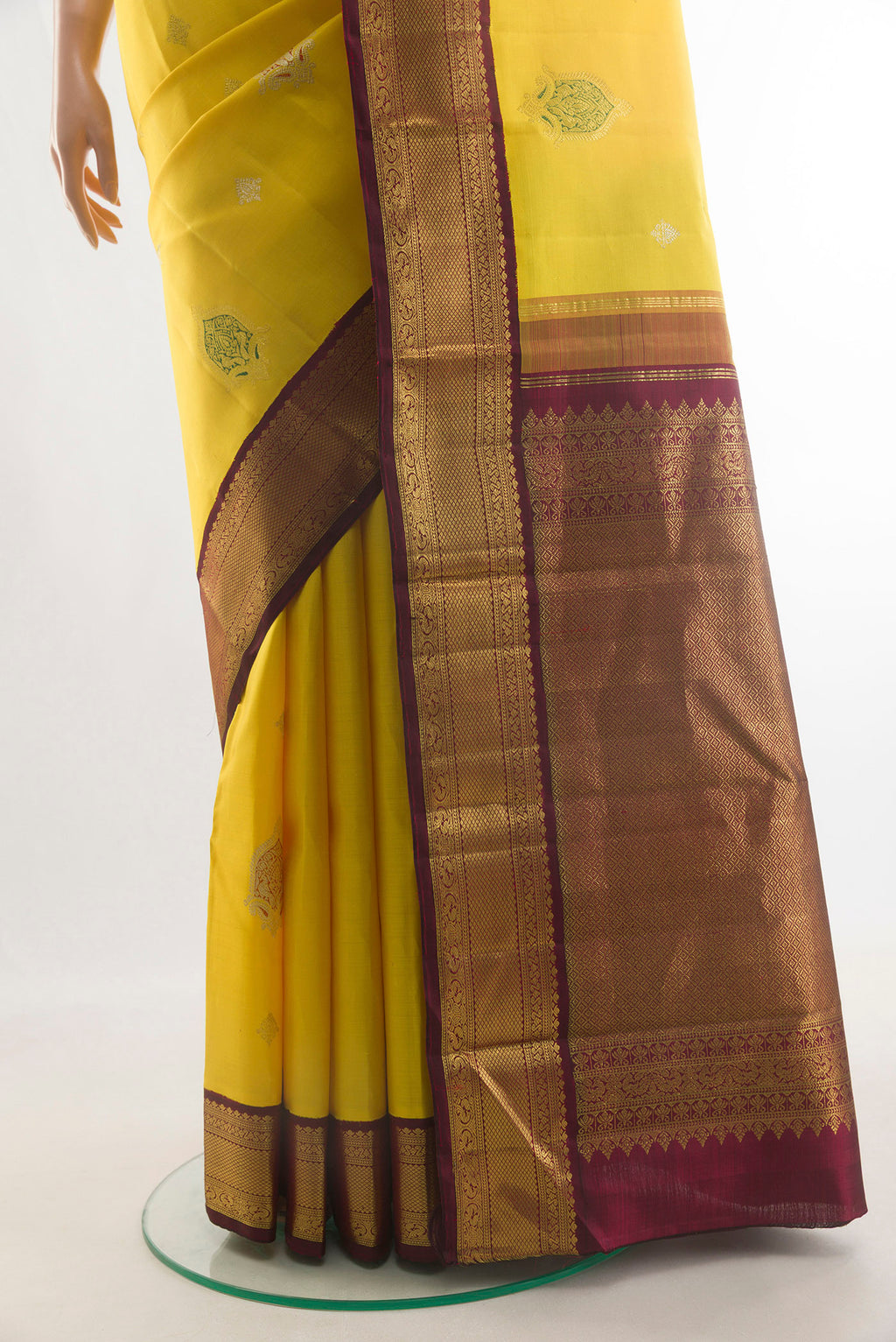 Pleats and pallu of Pure Silk Yellow Kanjivaram Saree with Zari Butta on the body and Zari Border. 