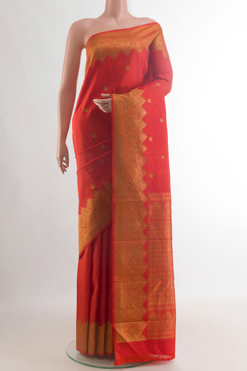 Pure Silk Red Kanjivaram Saree with Zari Butta on the body and Zari Border.  displayed on a mannequin
