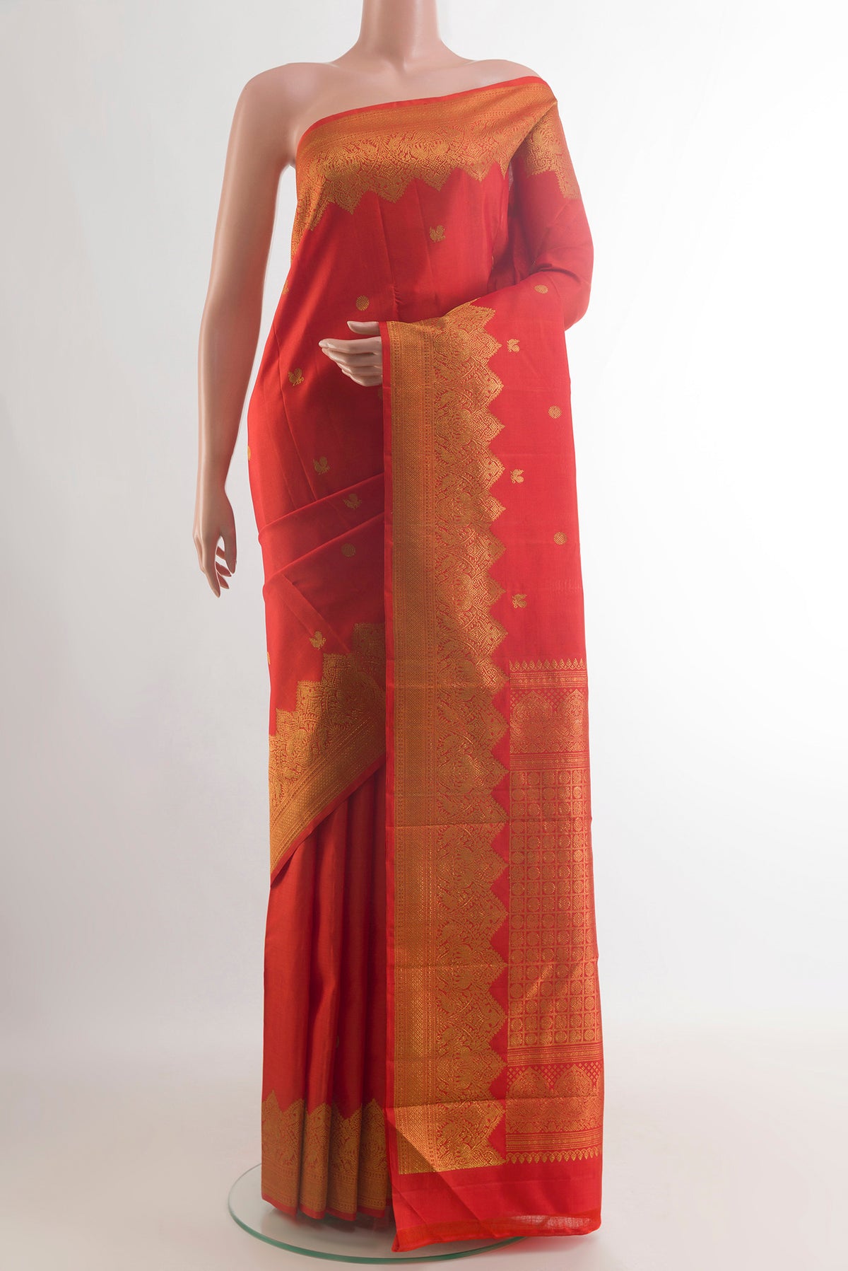 Pure Silk Red Kanjivaram Saree with Zari Butta on the body and Zari Border.  displayed on a mannequin