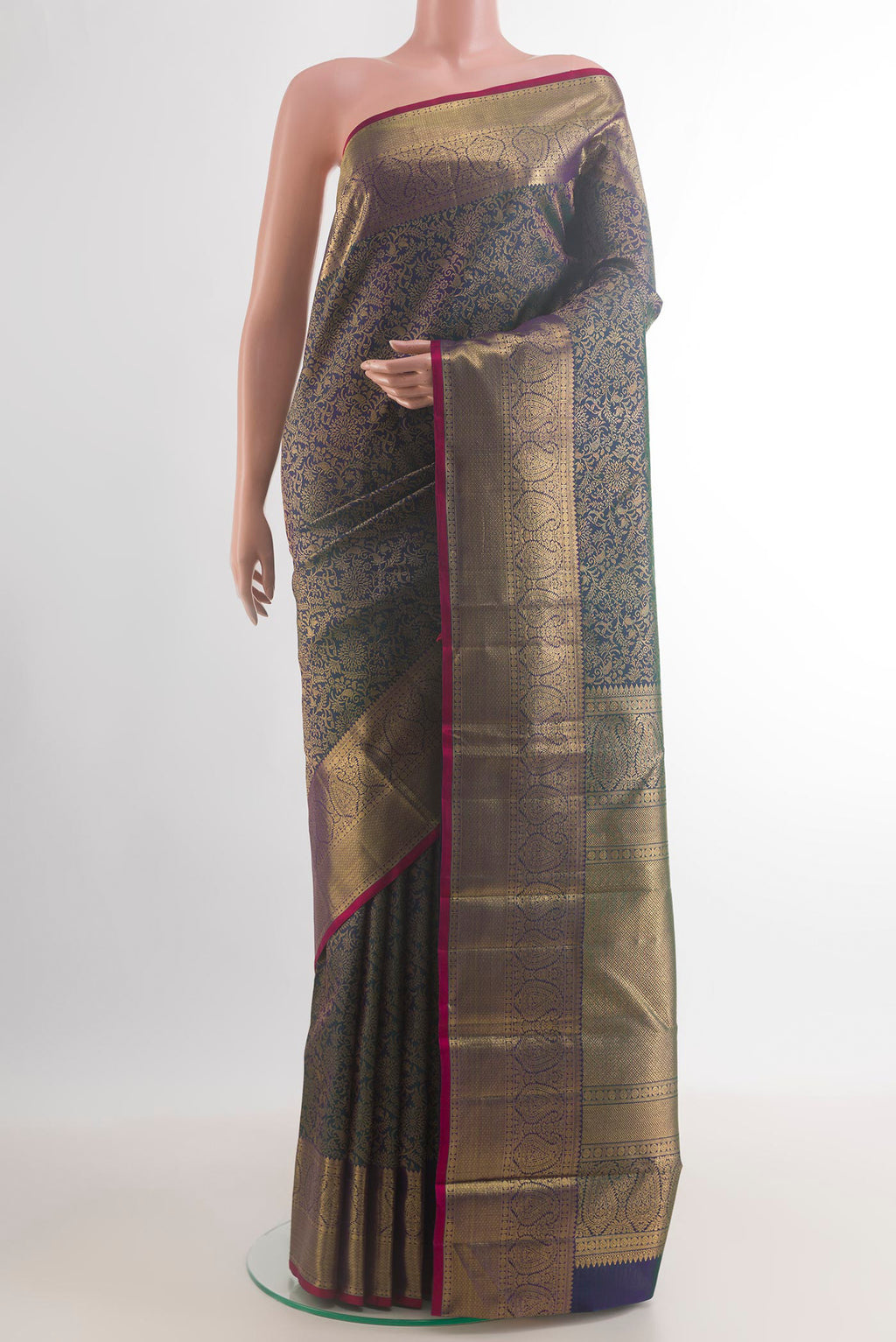 Pure Silk Bottle Green Kanchipuram Saree with Zari Brocade on the body and Zari Border.  displayed on a mannequin
