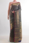 Pure Silk Bottle Green Kanchipuram Saree with Zari Brocade on the body and Zari Border.  displayed on a mannequin