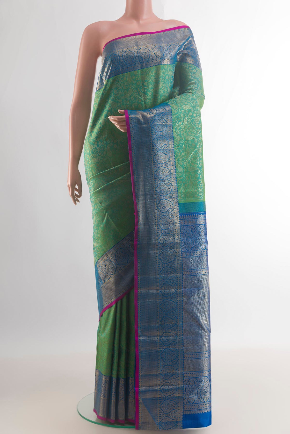 Pure Silk Green Kanchipuram Saree with Zari Brocade on the body and Zari Border.  displayed on a mannequin