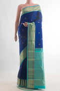 Pure Silk Blue Kanchipuram Saree with Zari Butta on the body and Zari Border.  displayed on a mannequin