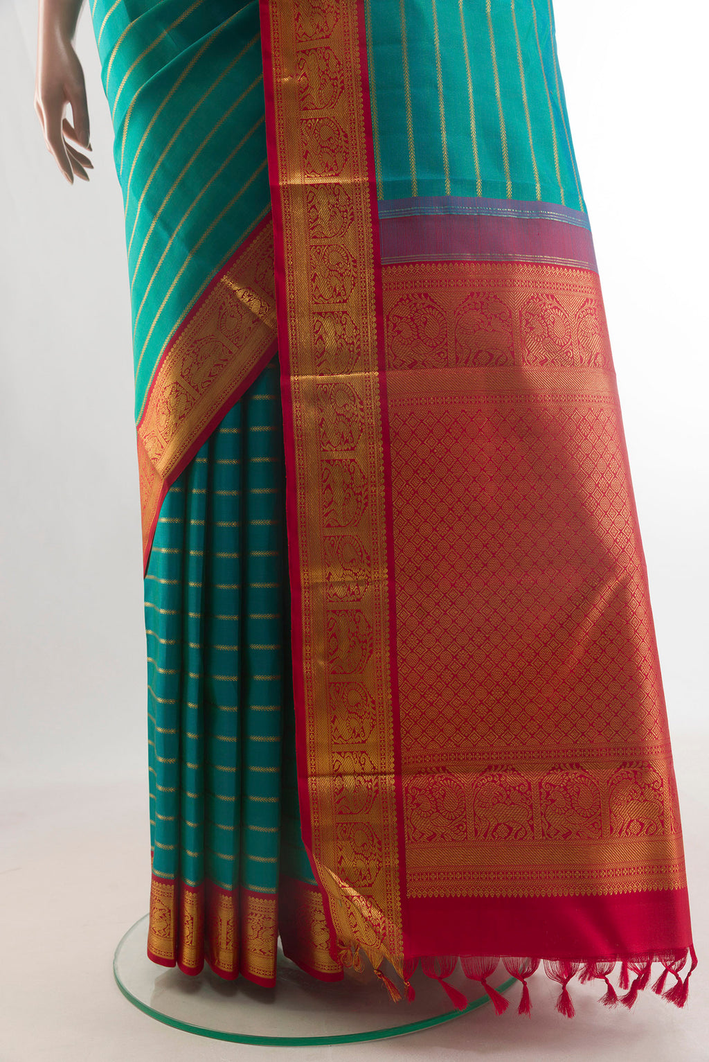 Pleats and pallu of Pure Silk Sea Green Kanchipuram Saree with Stripes on the body and Zari Border. 