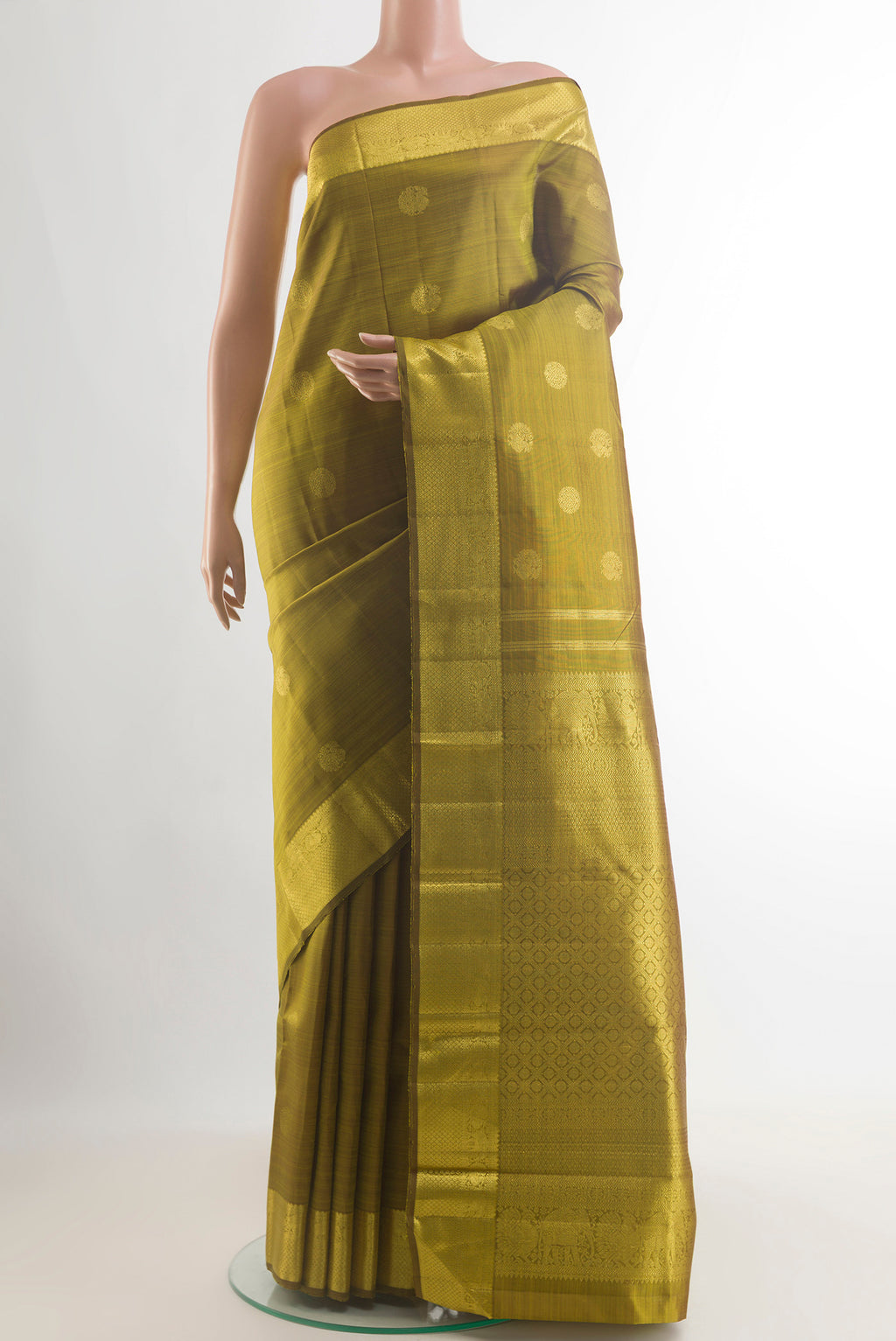 Pure Silk Mehandi Green Kanjivaram Saree with Zari Butta on the body and Zari Border.  displayed on a mannequin