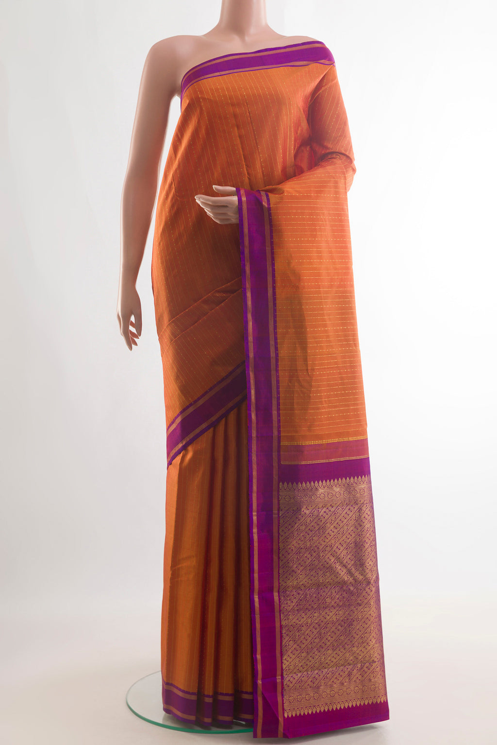 Pure Silk Brick Orange Kanchipuram Saree with Stripes on the body and Zari Border.  displayed on a mannequin