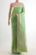 Pure Silk Pista Green Kanchipuram Saree with Plain Body and Zari Border.  displayed on a mannequin