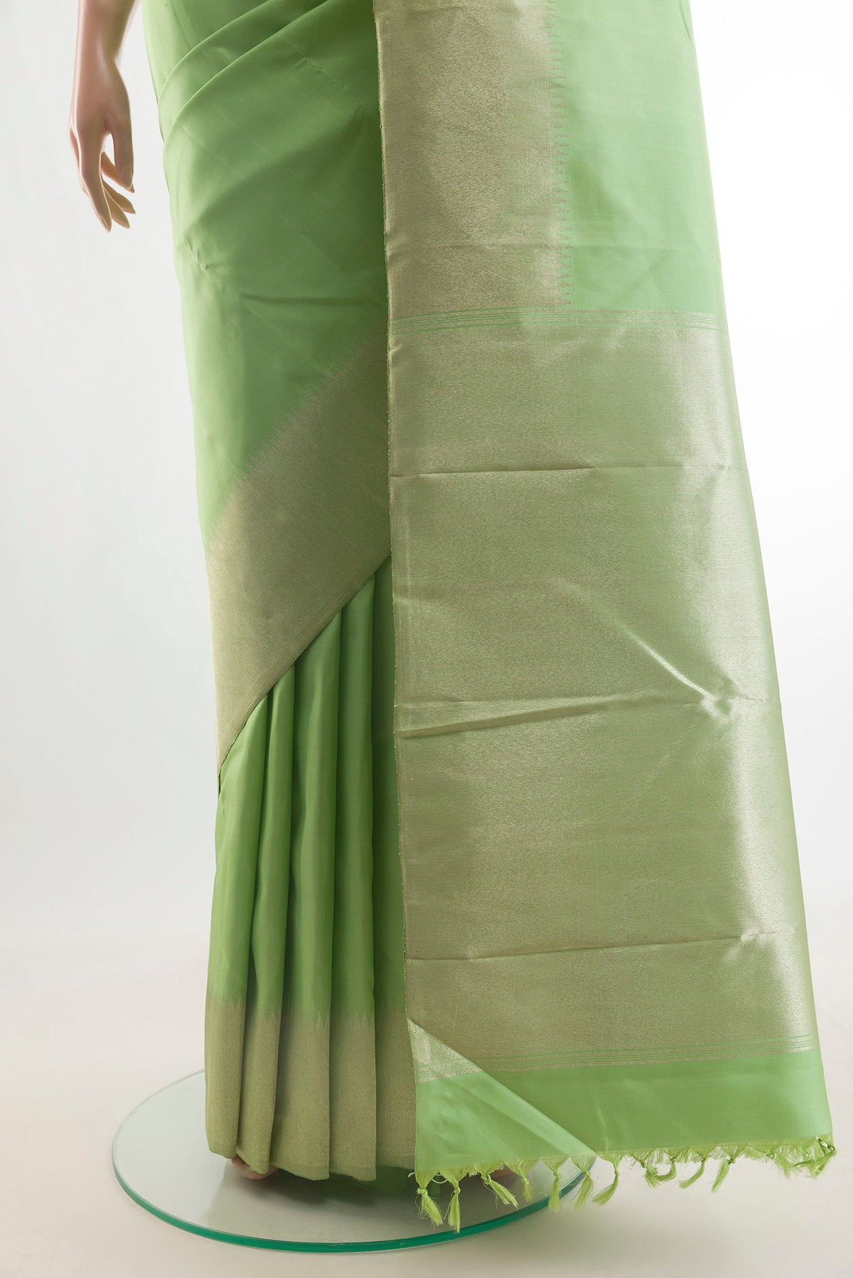 Pleats and pallu of Pure Silk Pista Green Kanchipuram Saree with Plain Body and Zari Border. 