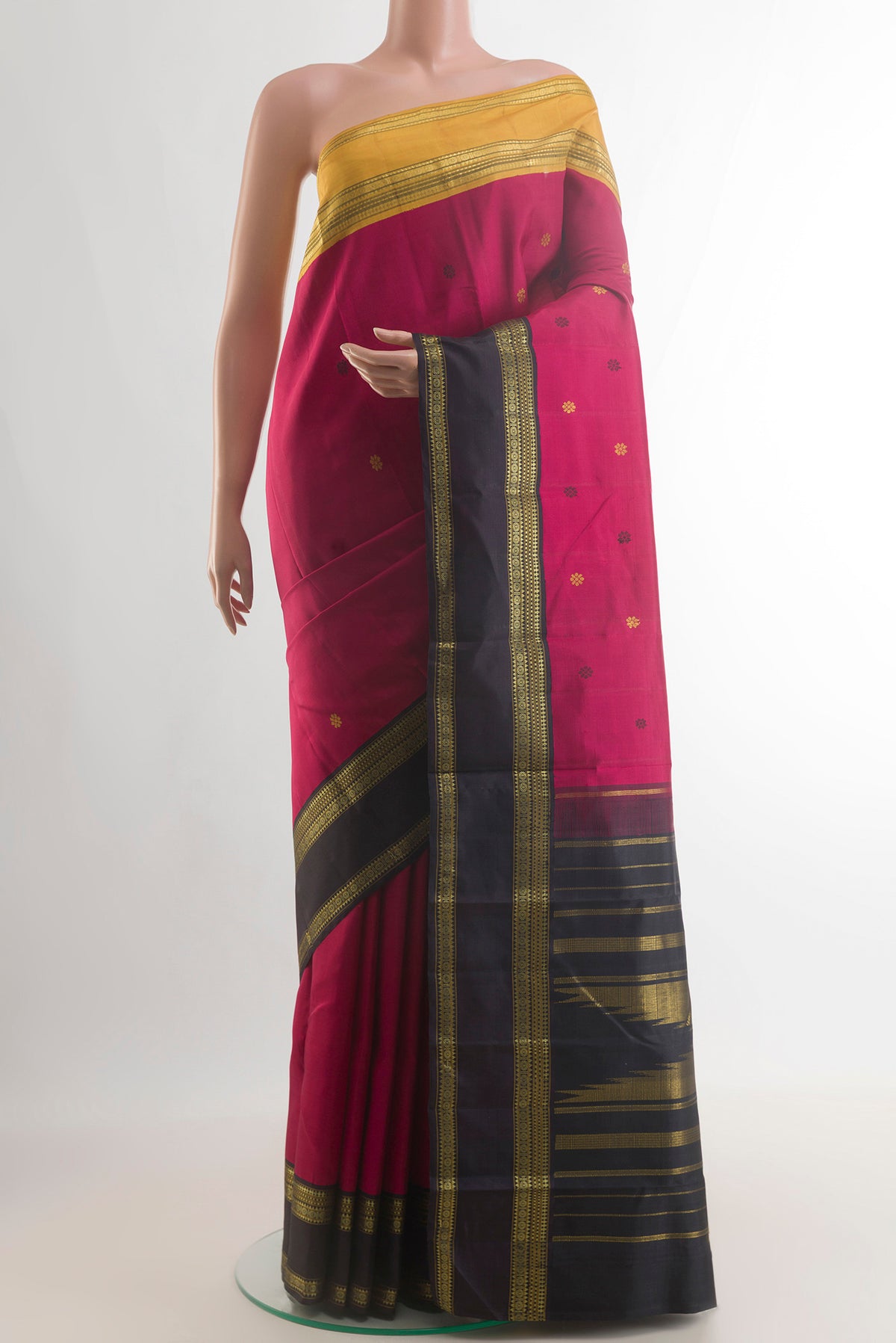 Pure Silk Pink Kanjivaram Saree with Thread Butta on the body and Ganga Jamuna Border.  displayed on a mannequin