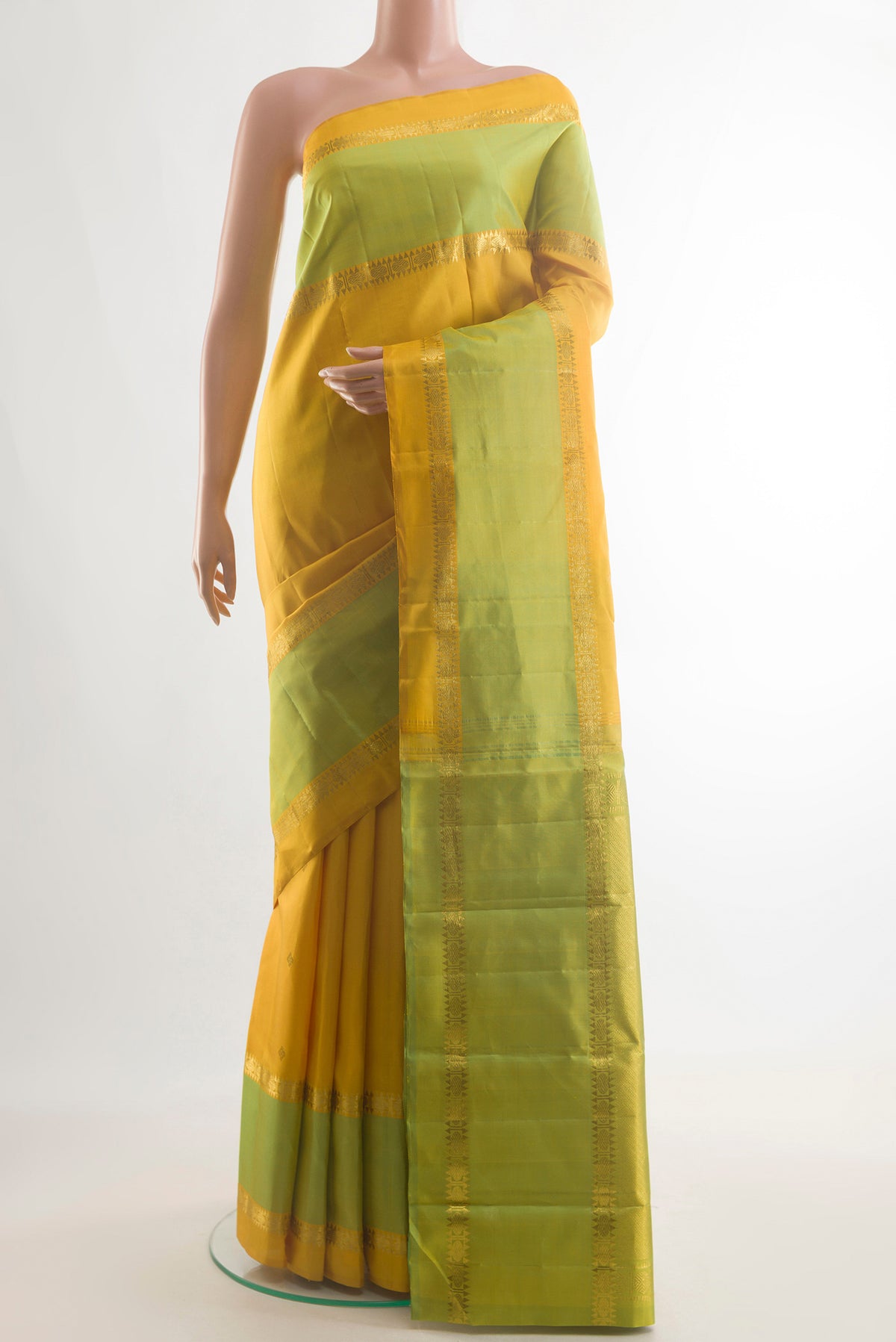 Pure Silk Yellow Kanjivaram Saree with Zari Butta on the body and Zari Border.  displayed on a mannequin